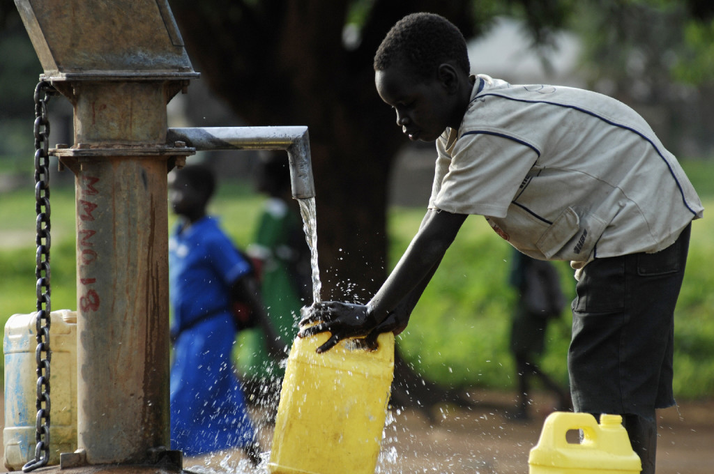 SUDAN: A boy fills jerrycans with water at a variation of a Mark II handpump near a primary school in Munuki Payam, a north-western sub-district of Juba, capital of Southern Sudan. UNICEF supports the construction of new water sources, and the repair, rehabilitation and maintenance of existing water points in schools, health facilities and communities. In June 2007 in Southern Sudan, the Government continues to rebuild its destroyed education system following more than two decades of civil war. The signing of the peace agreement in 2005 and the launch of the Go To School initiative in 2006 has resulted in a dramatic rise in the number of children in school. Go to School, launched by the Government in April 2006 with support from UNICEF and other partners, aims to enrol 1.6 million children by the end of 2007. More than 850,000 children in the largely autonomous region are currently enrolled – up from a low 343,000 during the war. Girls now comprise more than one-third of students. Just 1 per cent of girls complete primary school, with early marriage and a lack of adequate school facilities contributing to their absence. One exception is 16-year-old Suku Jane Simon from Central Equatoria State who has completed primary school and graduates from secondary school in 2008. Suku is the eldest of six children and lives in Juba, capital of Southern Sudan. She was partly educated in a refugee camp in Uganda, where the family fled during the war. Suku is now a second-year student at Juba Day Secondary School and is a leader in the school’s GEM club. All of the school-age children in her family are also in school. The Girls’ Education Movement (GEM) is a UNICEF-supported grassroots initiative that promotes equality in education through child participation. UNICEF also supports fast-track teacher-training to improve education quality, construction and rehabilitation of schools, and the provision of school supplies and recreational materials, as well as health